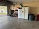 Spacious two car garage with storage shelves and a refrigerator at 229 Durrell Rd, Winter Haven, FL 33884