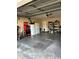 Spacious two car garage with storage shelves and a refrigerator at 229 Durrell Rd, Winter Haven, FL 33884