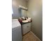 Laundry room with sink and vanity next to washing machine with cabinets, and tile flooring at 229 Durrell Rd, Winter Haven, FL 33884