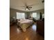 Cozy bedroom with hardwood floors, ceiling fan, and natural light at 229 Durrell Rd, Winter Haven, FL 33884