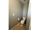 Powder room with toilet, tile floor, and neutral paint at 229 Durrell Rd, Winter Haven, FL 33884