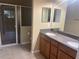 Bright bathroom featuring a double sink vanity and a glass-enclosed walk-in shower at 2673 Rutledge Ct, Winter Haven, FL 33884