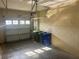 Spacious two-car garage with a garage door and recycling bins at 2673 Rutledge Ct, Winter Haven, FL 33884