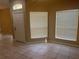 Bright living room featuring neutral tile flooring, large windows, and natural light at 2673 Rutledge Ct, Winter Haven, FL 33884