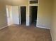 Comfortable main bedroom featuring neutral carpeting, and entrances to a closet and bathroom at 2673 Rutledge Ct, Winter Haven, FL 33884