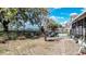 Backyard featuring black metal fence, mature tree, lounge chairs and access to lake at 2706 Rochelle Dr, Winter Haven, FL 33881