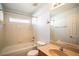 Traditional bathroom with a shower-tub combo, vanity, and neutral tile at 2706 Rochelle Dr, Winter Haven, FL 33881