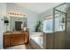 Elegant bathroom showcasing a glass shower, soaking tub, and double sink vanity at 2706 Rochelle Dr, Winter Haven, FL 33881