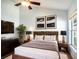 Comfortable bedroom featuring a cozy bed, modern furnishings, and a window providing natural light and garden views at 2706 Rochelle Dr, Winter Haven, FL 33881