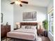 Stylish bedroom with a comfortable bed, modern decor, and a window offering natural light and views at 2706 Rochelle Dr, Winter Haven, FL 33881