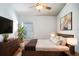 Cozy bedroom with a comfortable bed, modern dresser, and a window providing natural light for relaxation at 2706 Rochelle Dr, Winter Haven, FL 33881
