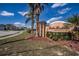 Street-level view of the community sign with beautiful blue sky and some neighborhood street at 2706 Rochelle Dr, Winter Haven, FL 33881