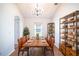Dining room with chandelier, wood table, and decorative shelves at 2706 Rochelle Dr, Winter Haven, FL 33881