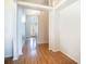 Bright foyer with hardwood floors leading to a charming front door with transom window, creating a welcoming entrance at 2706 Rochelle Dr, Winter Haven, FL 33881