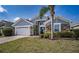 Single-story home featuring stone accents, an attached garage, and a well-manicured front lawn at 2706 Rochelle Dr, Winter Haven, FL 33881
