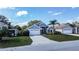 Charming single-story home featuring a two-car garage, stone accents, and a well-manicured front yard at 2706 Rochelle Dr, Winter Haven, FL 33881