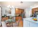 Charming kitchen with wood cabinets, stainless steel appliances and a breakfast table at 2706 Rochelle Dr, Winter Haven, FL 33881
