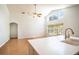 Open concept kitchen and living area with vaulted ceilings and hardwood floors at 2706 Rochelle Dr, Winter Haven, FL 33881