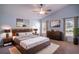 Spacious main bedroom with a plush bed, stylish decor, and windows offering natural light, creating a serene retreat at 2706 Rochelle Dr, Winter Haven, FL 33881