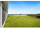 Backyard view showcasing the lake and lush green lawn at 2759 Grandbury Grove Rd, Lakeland, FL 33811