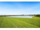 Picturesque backyard view of the tranquil lake and clear blue sky at 2759 Grandbury Grove Rd, Lakeland, FL 33811