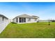Backyard featuring a screened patio and well-maintained green lawn at 2759 Grandbury Grove Rd, Lakeland, FL 33811