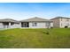 Spacious backyard featuring a well-manicured lawn and screened patio at 2759 Grandbury Grove Rd, Lakeland, FL 33811