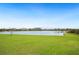 Expansive backyard with lush green grass and a serene lake view at 2759 Grandbury Grove Rd, Lakeland, FL 33811