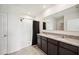 Bathroom with double vanity, granite countertop, a shower with dark curtain and tile floors at 2759 Grandbury Grove Rd, Lakeland, FL 33811