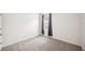 Bedroom featuring a large window and neutral carpet flooring at 2759 Grandbury Grove Rd, Lakeland, FL 33811