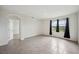 Bright bedroom with a large windows offering views of the backyard and neutral tile floors at 2759 Grandbury Grove Rd, Lakeland, FL 33811