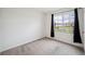 Bedroom with a large window and neutral carpet flooring at 2759 Grandbury Grove Rd, Lakeland, FL 33811