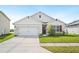 Charming single-story home with a well-maintained lawn and a two-car garage at 2759 Grandbury Grove Rd, Lakeland, FL 33811