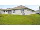 Exterior view of home with well-maintained lawn and stucco finish at 2759 Grandbury Grove Rd, Lakeland, FL 33811