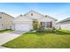 Charming single-story home with a well-maintained lawn and a two-car garage at 2759 Grandbury Grove Rd, Lakeland, FL 33811