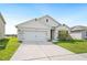 Charming single-story home with a well-maintained lawn and a two-car garage at 2759 Grandbury Grove Rd, Lakeland, FL 33811