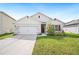 Charming single-story home with a well-maintained lawn and a two-car garage at 2759 Grandbury Grove Rd, Lakeland, FL 33811