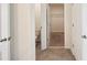 Hallway view showcasing tiled flooring and access to a toilet and walk in closet at 2759 Grandbury Grove Rd, Lakeland, FL 33811