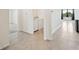 Hallway with tile floors, laundry nook, and an open floor plan at 2759 Grandbury Grove Rd, Lakeland, FL 33811
