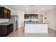 Open kitchen offers stainless appliances, dark cabinets and a large center island with breakfast bar at 2759 Grandbury Grove Rd, Lakeland, FL 33811