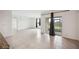 Spacious living room featuring sliding glass doors to covered patio and neutral tile flooring at 2759 Grandbury Grove Rd, Lakeland, FL 33811