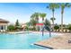 Community swimming pool with lounge chairs, umbrellas, and a shallow splash area for  at 2759 Grandbury Grove Rd, Lakeland, FL 33811
