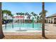 Community swimming pool with water features, palm trees, and a lounge area for relaxation at 2759 Grandbury Grove Rd, Lakeland, FL 33811