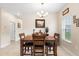 Bright dining room featuring a wooden table with seating for four and a charming chandelier at 2824 Attwater Loop, Winter Haven, FL 33884