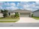 Charming one-story home with a manicured lawn and a two-car garage at 283 Lake Lucerne Way, Winter Haven, FL 33881