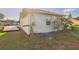 A home's backyard with green grass and a trailer parked on the side at 31 Wagon Cir, Kissimmee, FL 34743