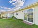 Backyard with sliding glass doors, patio area, and well-maintained lawn at 31 Wagon Cir, Kissimmee, FL 34743