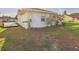 Side and back yard featuring green lawn and partial view of the home's exterior at 31 Wagon Cir, Kissimmee, FL 34743