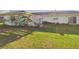 A large backyard with a well-maintained lawn and a white patio divider, with a light green home exterior at 31 Wagon Cir, Kissimmee, FL 34743