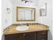 Bathroom features a vanity with brown accents and a large framed mirror at 31 Wagon Cir, Kissimmee, FL 34743